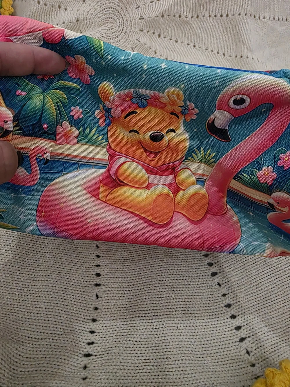 Insulated lunch bag features a playful design of Winnie the Pooh wearing a color